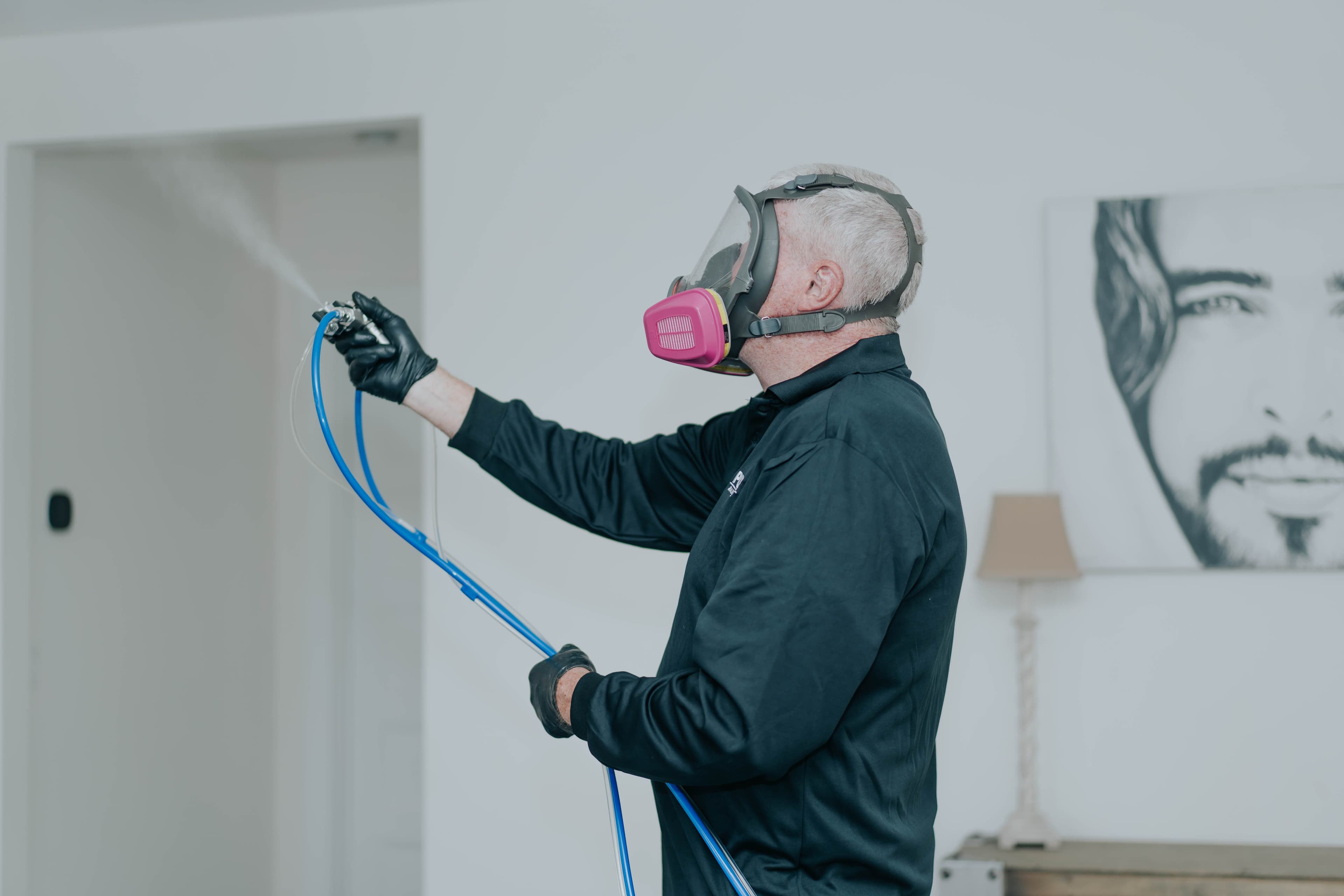 Technician administering dry fog treatment in a residential room
